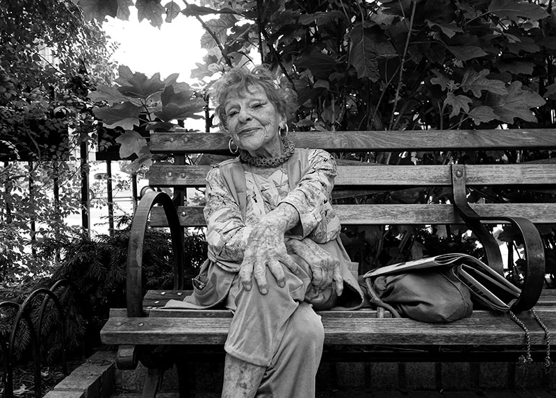 Elderly Lady Sitting on a Park Bench